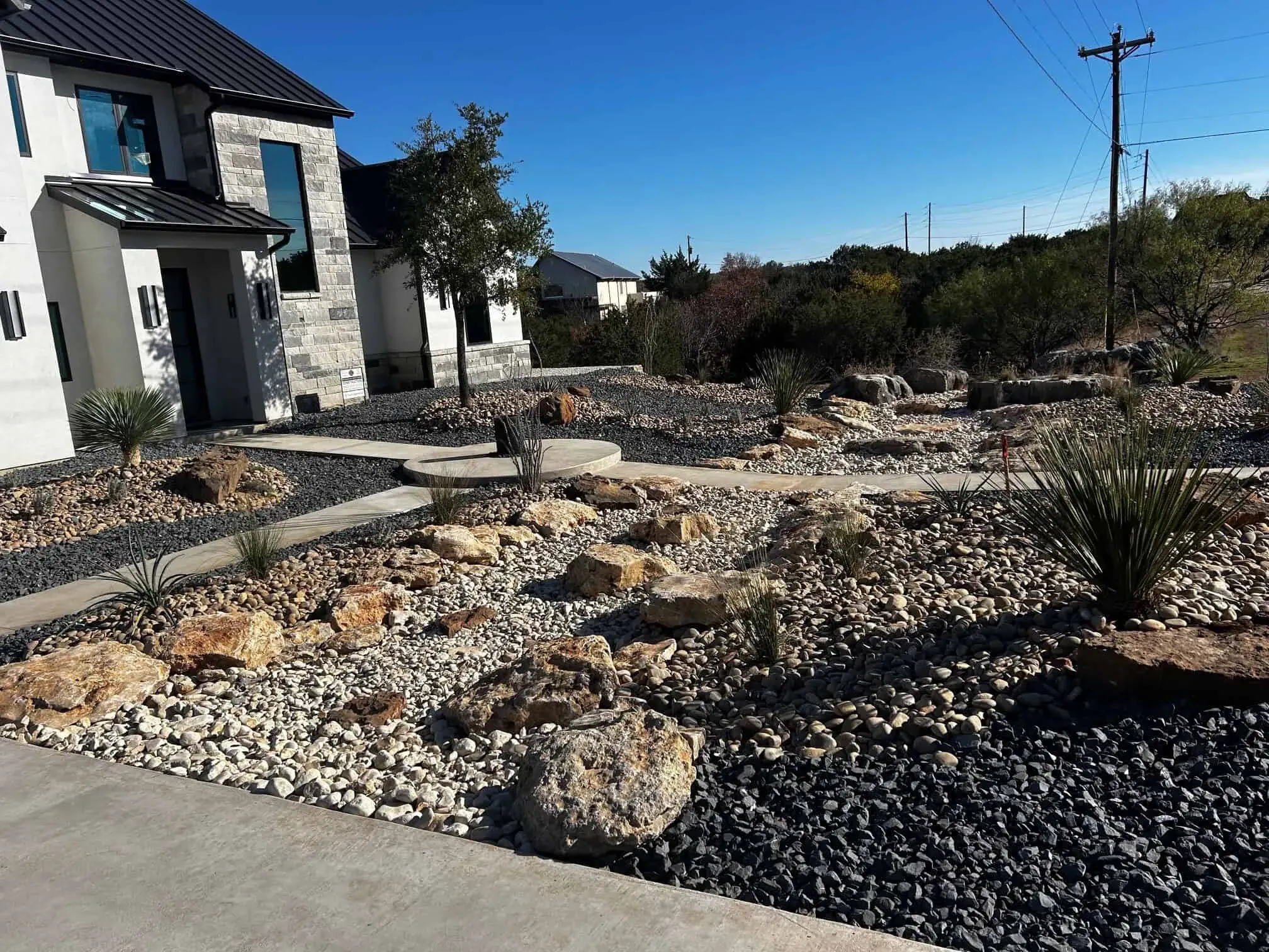 Homeowner consulting with landscaping professional over design plans in a garden